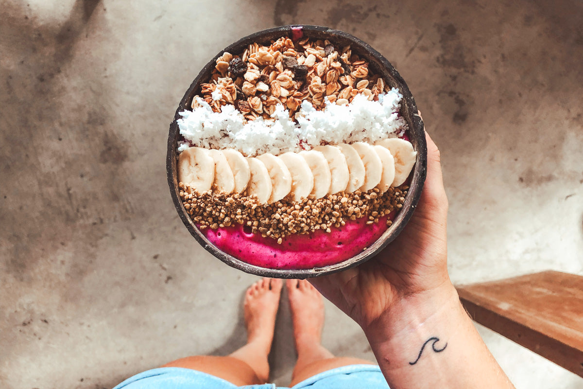 Bol de flocons d'avoine avec banane, coco et purée de fruit pour le petit-déjeuner