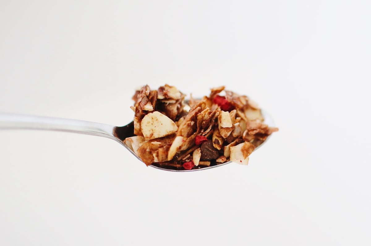Cuillère de granola avec des morceaux de pomme et des éclats d'amandes Image